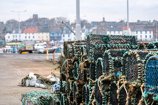 Stack of lobster traps in a port of Anstruther, a fishing village on a Scottish coast