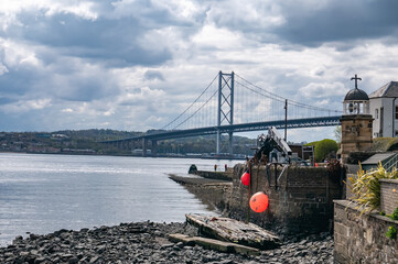 Landscape view of Forth Road Bridge over river Forth from the shore in North Queensferry