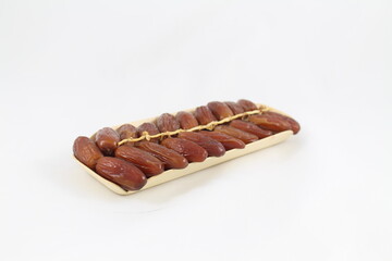 Cardboard tray of date fruits on grey background