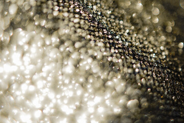 Background of abstract glitter lights. Gold, silver and black bokeh banner.