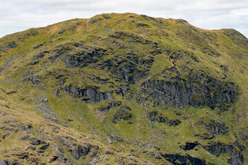 View of An Caisteal hill slope. Beautiful green Scottish mountain scenery in the Trossachs National Park in summer 