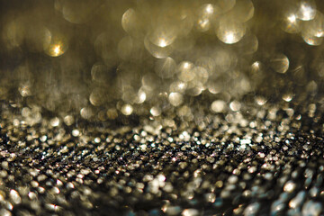 Background of abstract glitter lights. Gold, silver and black bokeh banner.