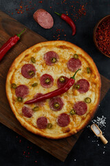 pizza with salami on a board, pepperoni pizza