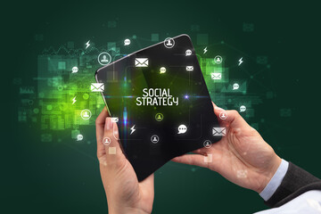 Businessman holding a foldable smartphone, social media concept