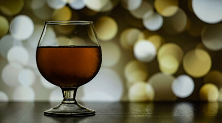 a glass with a wine on the bokeh circle background 