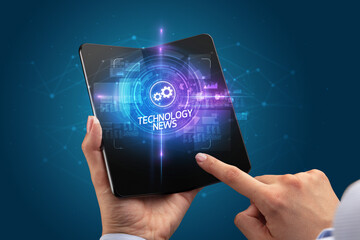 Businessman holding a foldable smartphone, technology concept