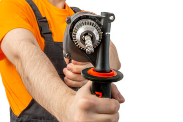 Young worker drilling with electric drill in his hands. Tool for boring holes. Craftsman repairman wearing orange uniform cap and t-shirt, overalls on a white isolated background for advertising
