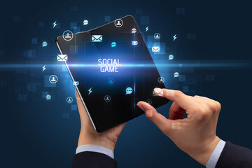 Businessman holding a foldable smartphone, social media concept
