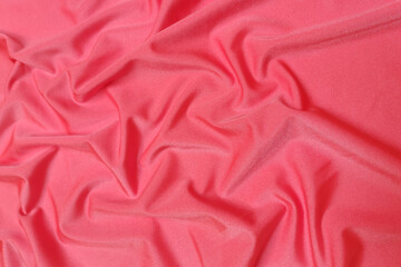 Pink supplex crumpled or wavy fabric texture background. Abstract linen cloth soft waves. Silk fabric. Smooth elegant luxury cloth texture. Concept for banner or advertisement.