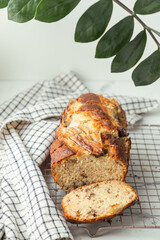 Fresh banana bread on the white background. Homemade pastry on the checkered cloth