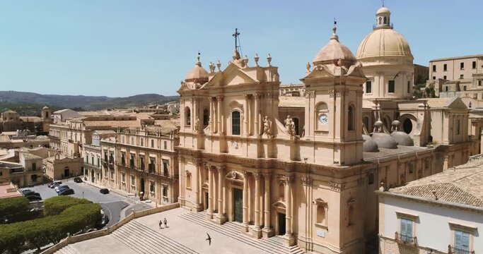 Zoom out aerial view of Noto and the ancient historical baroque tuff St. Nicholas cathedral in Italy.