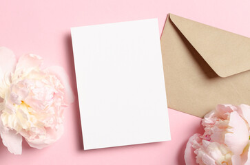 Blank greeting or invitation card mockup with envelope and pink peony flowers