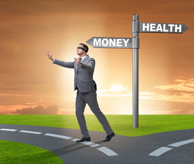 Businessman choosing between money and health