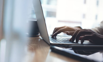 Man hands typing on laptop computer keyboard, close up. E-business, online job. Business man...