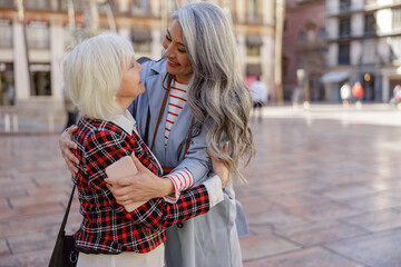 Enthusiastic women spending time together in city