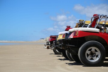 Colorful ATV quadricycles lined up on the sand waiting for tourists for off road adventure on the...