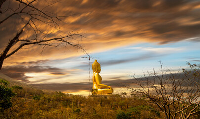 The golden buddha statue on mountain at Wat Khao Wong Phra Chan Temple, Lop Buri, Thailand. - obrazy, fototapety, plakaty