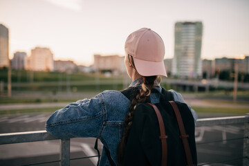 Tourist admires the overview of the sights of the city. Woman with backpack enjoy beautiful city view, traveler mock up top of the city. - 517355988
