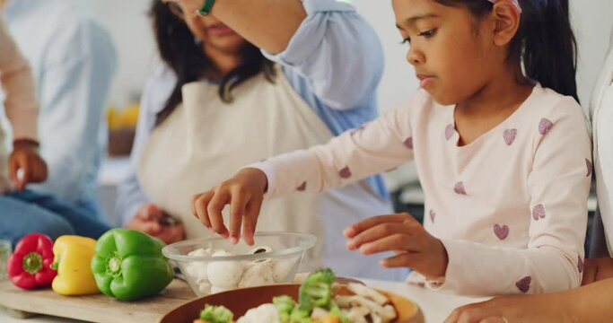 Happy Family Cooking Dinner Together In The Home Kitchen At Home. Young Girl Helping Her Grandmother Prepare A Healthy Meal With Vegetables. Independent Daughter Making Food With An Older Woman