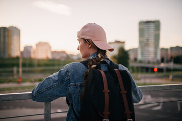 Tourist admires the overview of the sights of the city. Woman with backpack enjoy beautiful city view, traveler mock up top of the city. - 517356326
