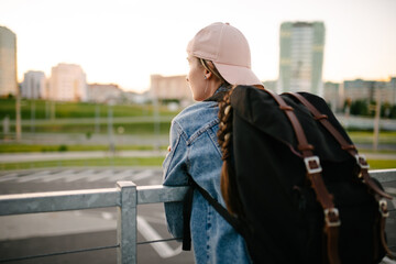 Tourist admires the overview of the sights of the city. Woman with backpack enjoy beautiful city view, traveler mock up top of the city. - 517356534