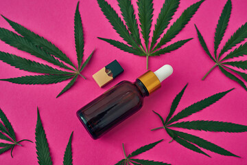 Cannabis leaves with oil and e-cigarette cartridge