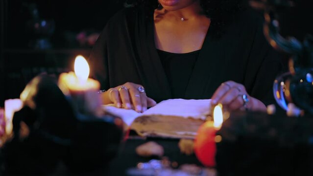 Fortuneteller reading magic spell book, learning ancient healing ritual, witch