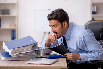 Young male employee working in the office