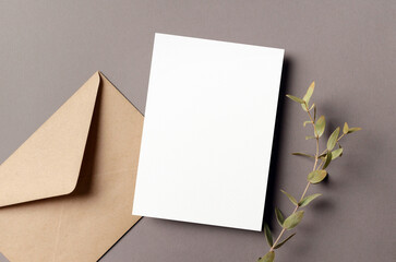 Invitation card mockup with envelope and dry eucalyptus twig