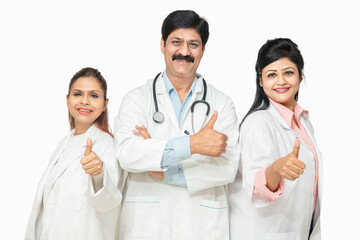 Fototapeta premium Portrait happy indian male and female doctors with stethoscope standing doing thumbs while looking at camera, healthcare and medical concept.