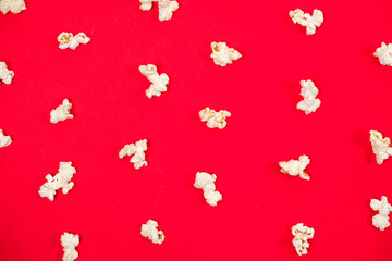 Popcorn on a red background, close-up view from above