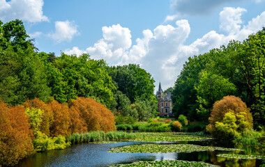 Pool in a nature reserve in West Flanders, Belgium with detail of a country villa

