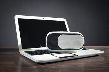 Virtual reality glasses with a laptop computer on the table.