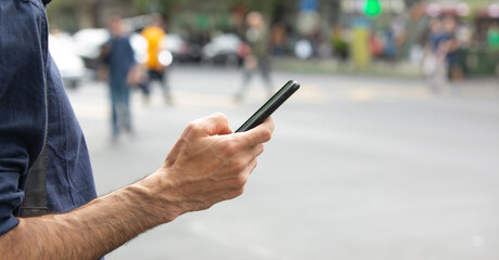 Caucasian man using smartphone in the city.