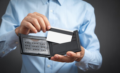 Man holding credit card and wallet.