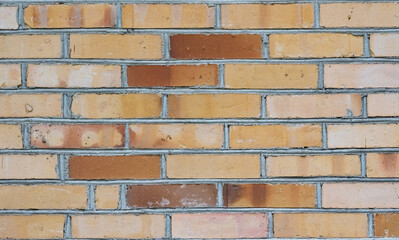 Brick wall. Background of bright red bricks. Classic industrial background made of small red blocks.