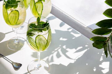 Three cocktails with ice, cucumbers and mint