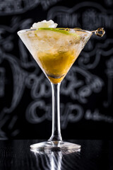 Cocktail with apple, olives, flowers and ice