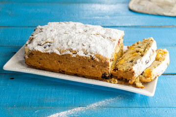 Cupcake with nuts and dried fruits on a white plate on a blue background. food concept