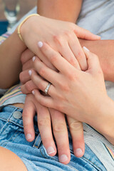 Fototapeta na wymiar Hands of Young Couple and Engagement Ring