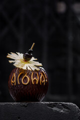 Cocktail with ice, lemon, dried pineapple, cherry on a stick