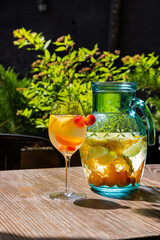 Juice with peaches and cherries in a glass
