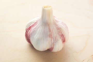 Raw garlic on the wooden table background, close-up. Organic garlic for publication, poster, screensaver, wallpaper, postcard, banner, cover, post. Food cook rustic still