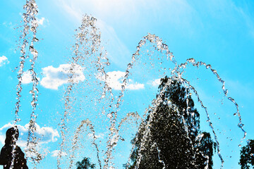 close-up water jet fountain against blue sky