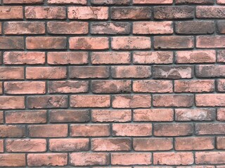 オレンジ色と茶系のレンガ壁の背景テクスチャ