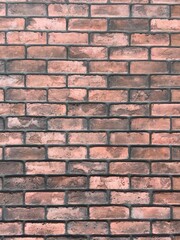 オレンジ色と茶系のレンガ壁の背景テクスチャ