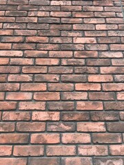 オレンジ色と茶系のレンガ壁の背景テクスチャ