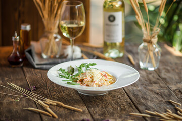 Portion of italian farfalle pasta with salmon on wooden background