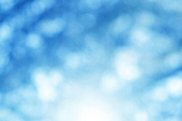 Light blue Leaf background. Blurred leaves and circular bokeh. Abstract wallpaper for backdrop and design