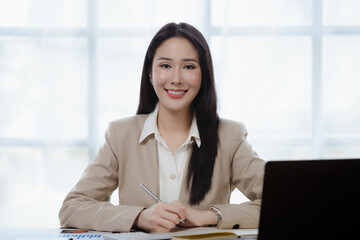 Beautiful Asian woman managing a company, business executive, marketing executive, founder of a startup company providing marketing services to clients. Marketing management concept.